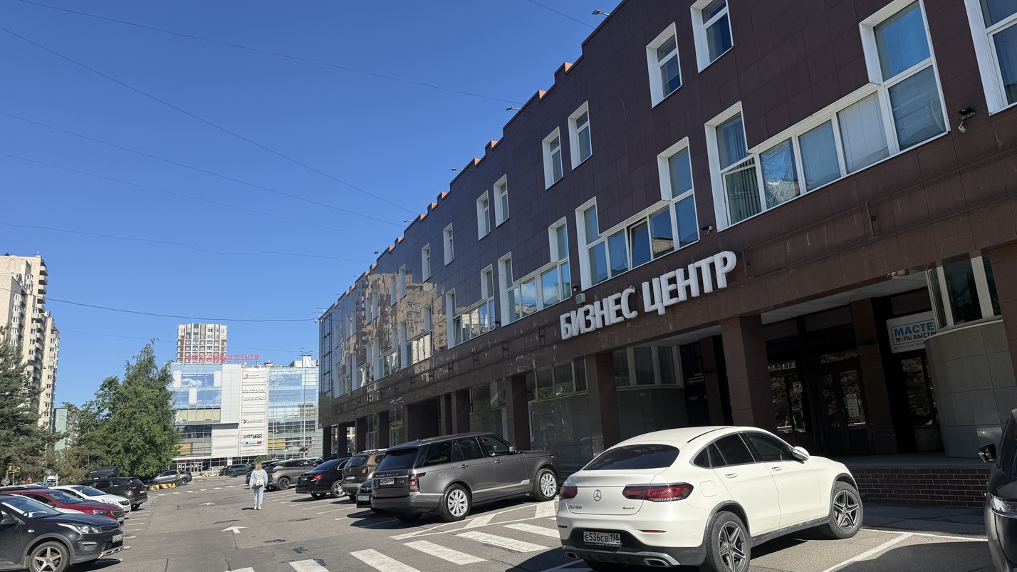 Идите по парковке вдоль БЦ